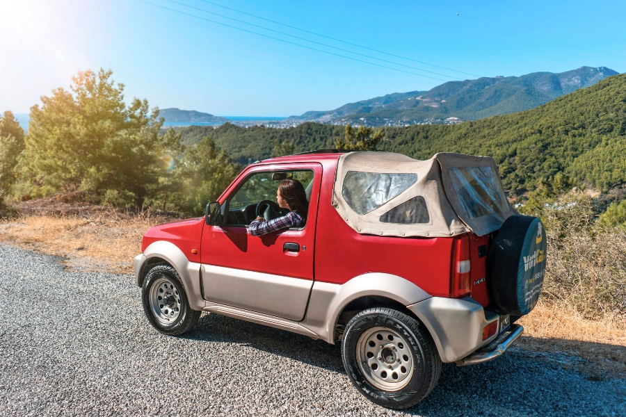 Woman Driving a Red Car