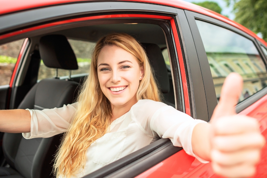 Woman Driving a Red Car