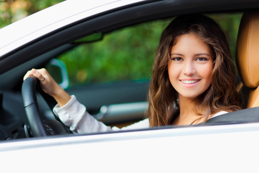 Woman Driving a White Car