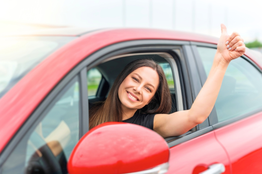 Woman Driving a Red Car